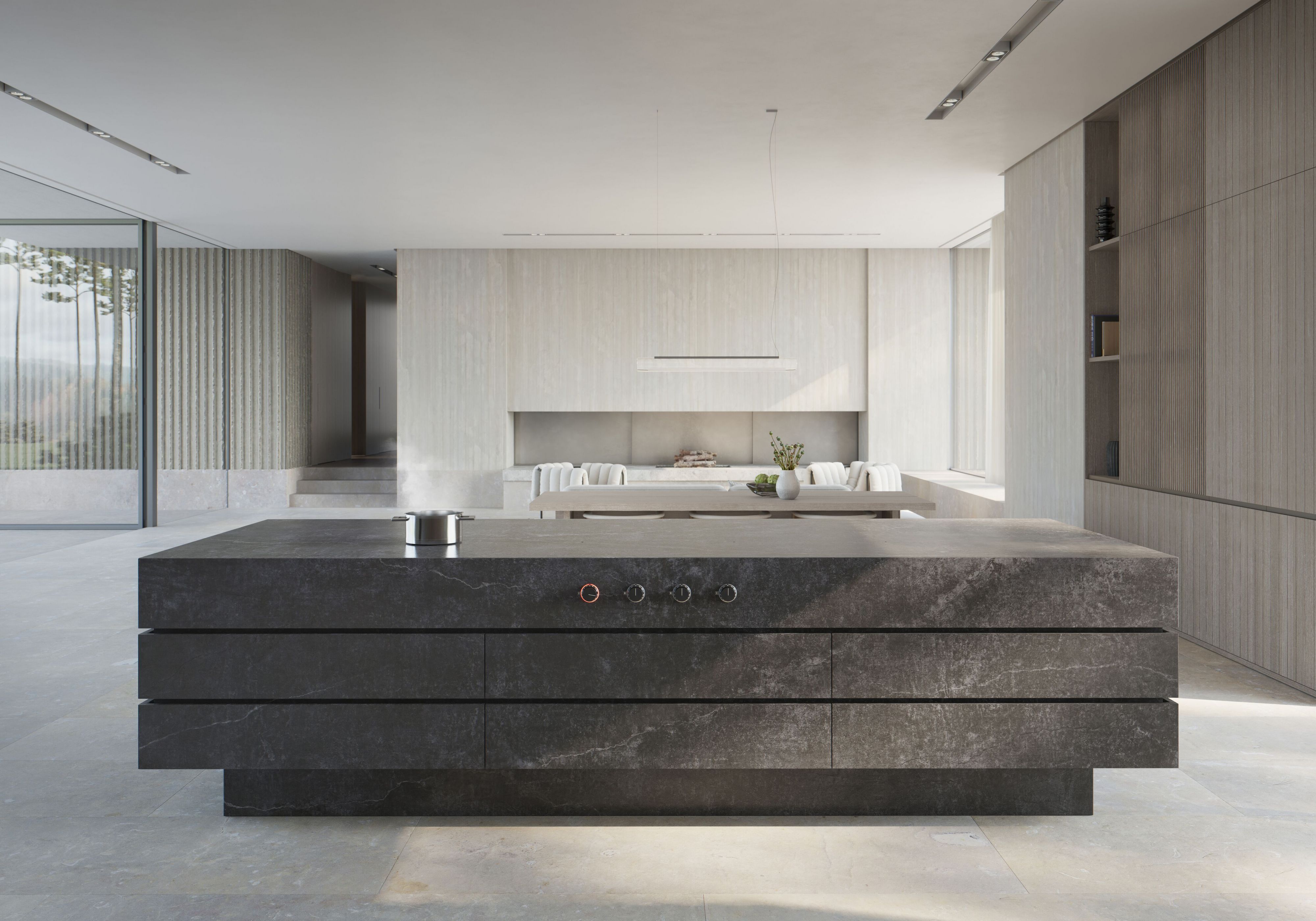 Kücheninsel aus dunklem Steinmaterial vor heller Wand in moderner, offener Küche von Gaggenau