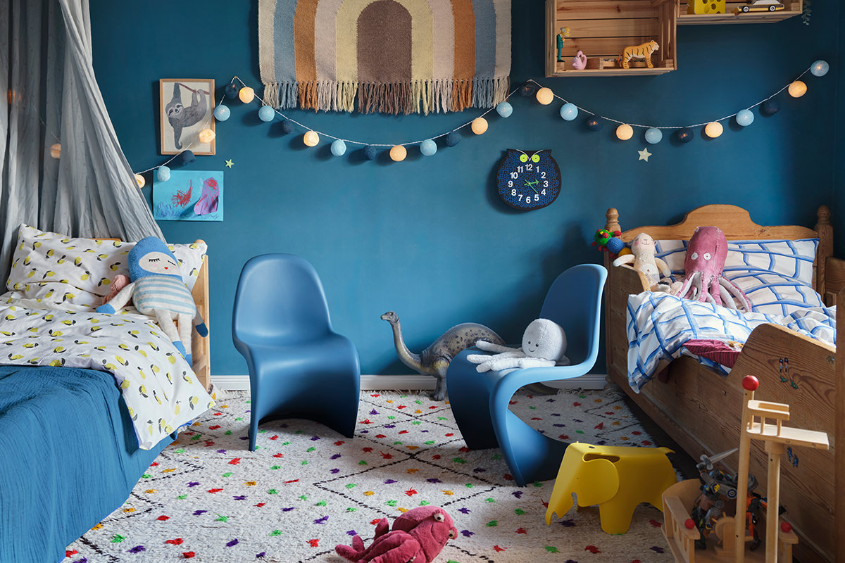 Buntes Kinderzimmer mit verspielten Vitra Möbeln: Panton Junior Stühle und Small Elephant bieten bequeme Sitz- & Spielmöglichkeiten. Die fröhliche Zoo Wanduhr unterstreicht das kinderfreundliche Ambiente.