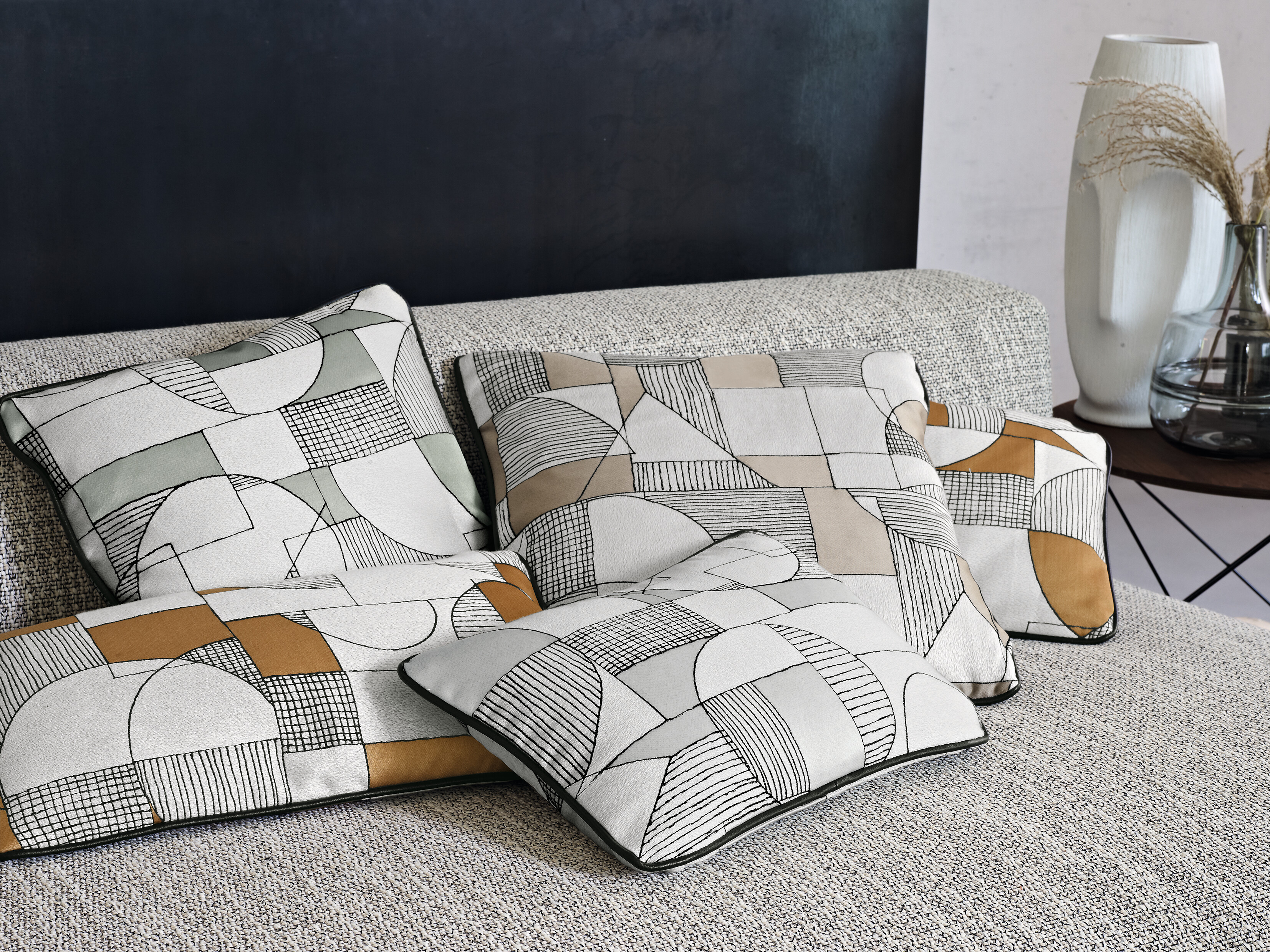 Beiger Stoffbezug auf Sofa mit Kissen vor Vorhängen in warmem Beige und Goldton